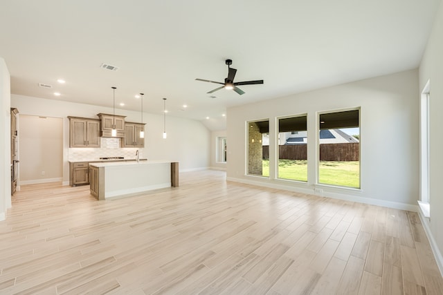 unfurnished living room featuring light wood-type flooring and ceiling fan