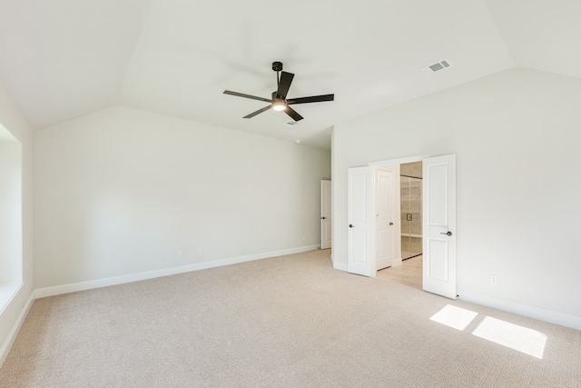 unfurnished bedroom with vaulted ceiling, light colored carpet, and ceiling fan