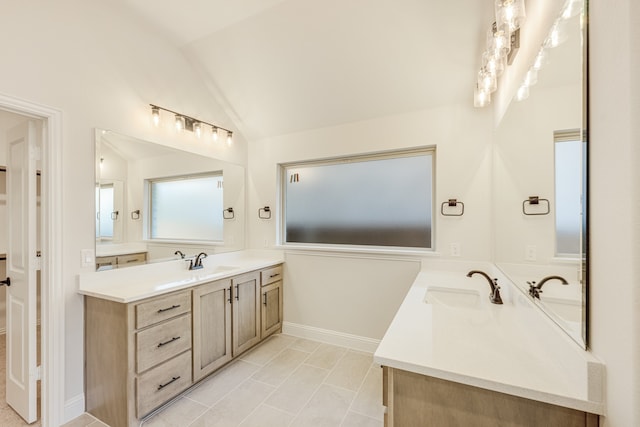 bathroom with vanity, lofted ceiling, and tile patterned flooring