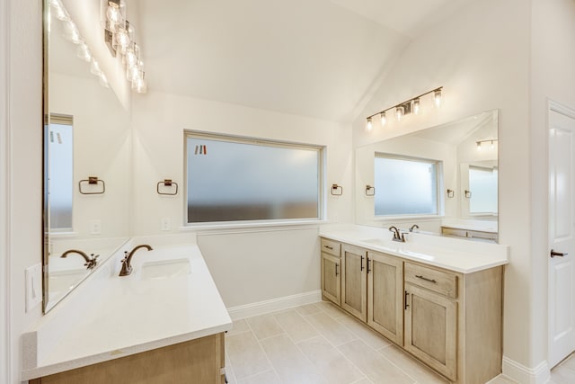 bathroom with vanity and vaulted ceiling