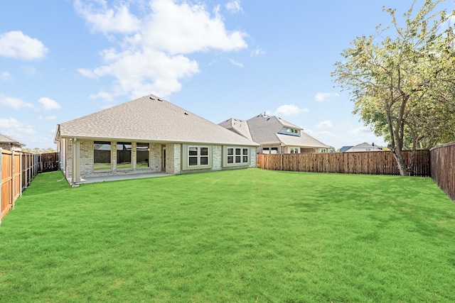 rear view of property featuring a lawn and a patio area