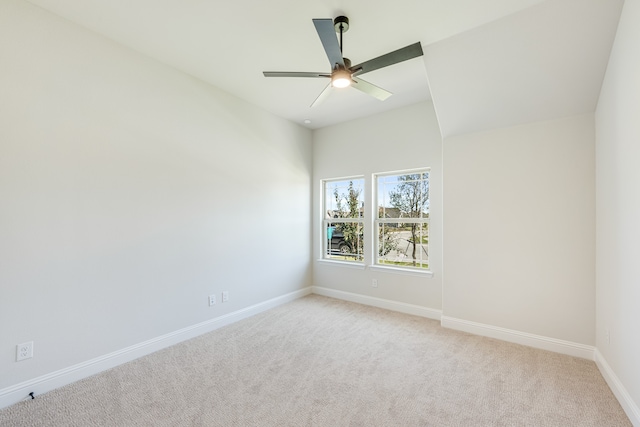 spare room featuring light carpet and ceiling fan