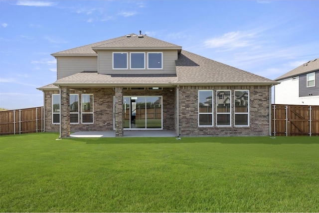 back of house with a lawn and a patio area