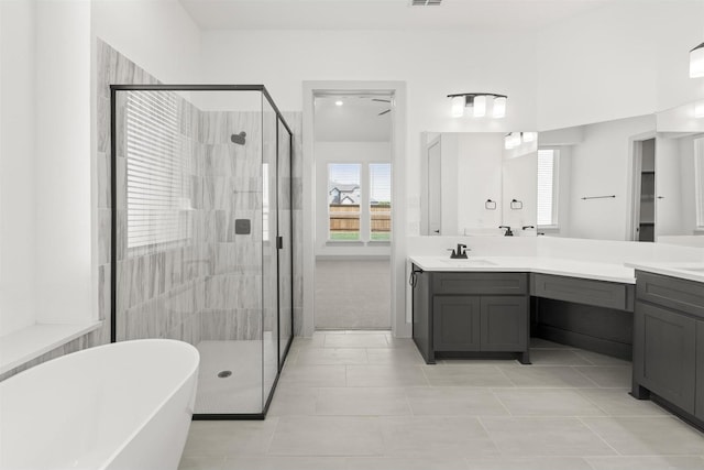 bathroom with vanity, tile patterned flooring, and independent shower and bath