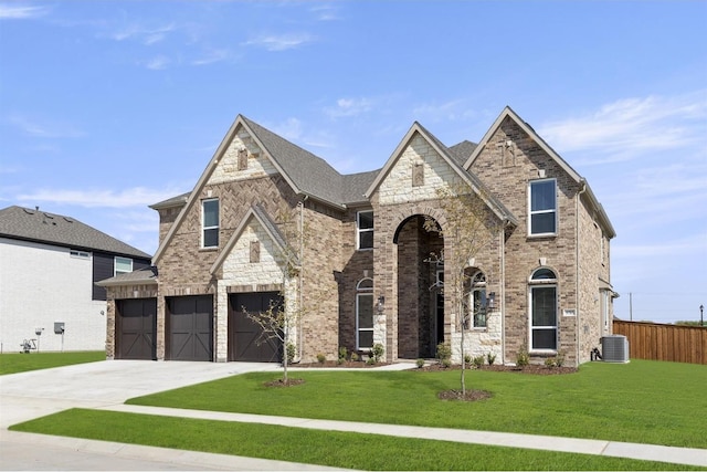 view of front facade with cooling unit, a garage, and a front lawn