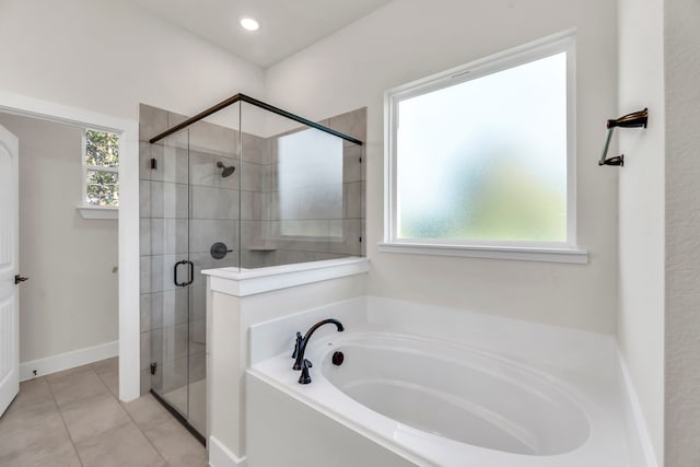 bathroom featuring tile patterned floors and separate shower and tub