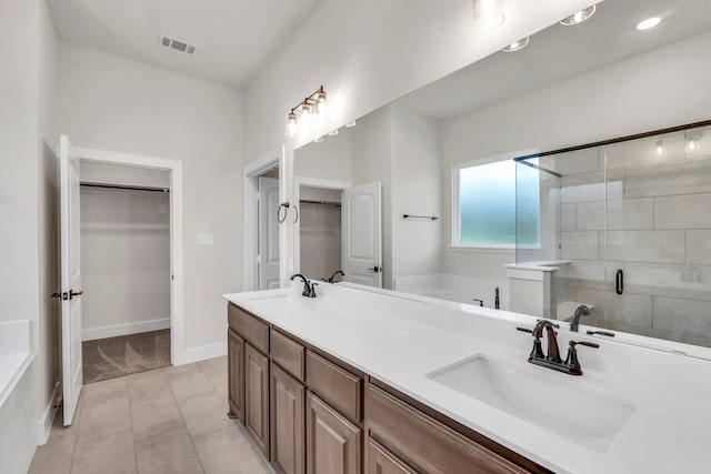 bathroom with independent shower and bath, vanity, and tile patterned flooring