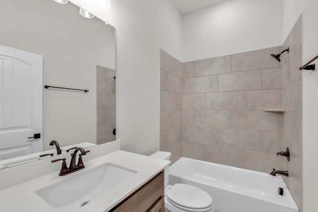 full bathroom featuring toilet, vanity, and tiled shower / bath