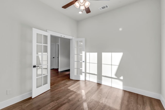 unfurnished room with dark hardwood / wood-style flooring, french doors, and ceiling fan