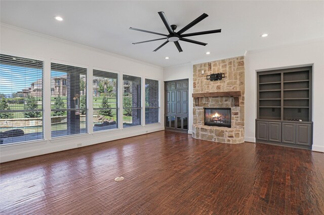 unfurnished living room with built in shelves, a fireplace, and dark hardwood / wood-style floors