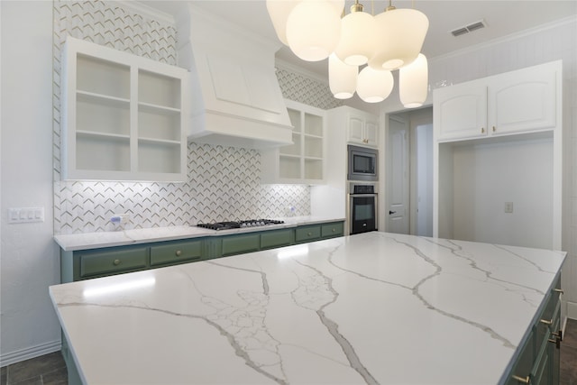 kitchen featuring appliances with stainless steel finishes, white cabinets, crown molding, custom exhaust hood, and a center island