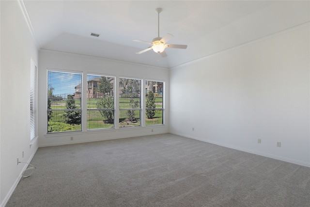 carpeted empty room with ornamental molding, a wealth of natural light, ceiling fan, and lofted ceiling