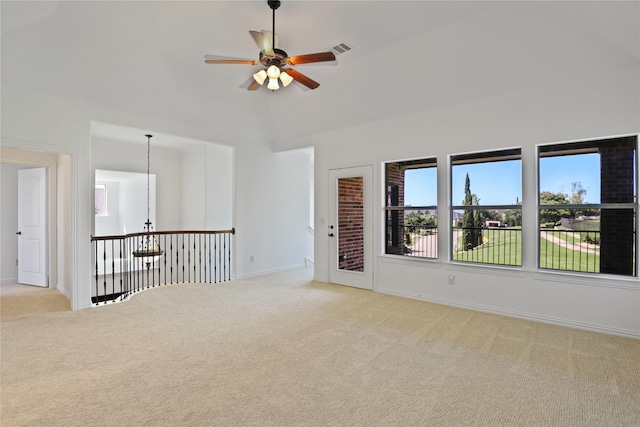 unfurnished room featuring ceiling fan with notable chandelier and carpet