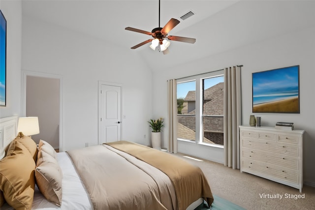 carpeted bedroom featuring high vaulted ceiling and ceiling fan