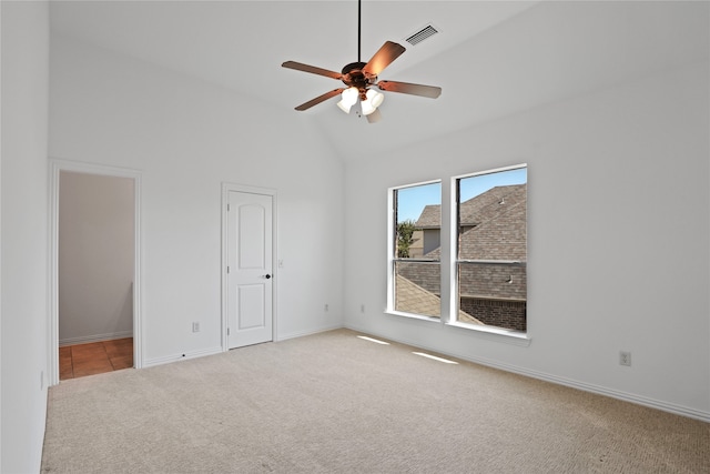 spare room with carpet, ceiling fan, and high vaulted ceiling