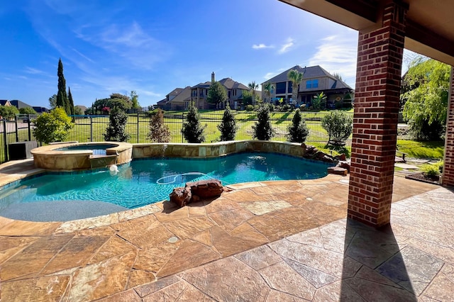 view of pool featuring an in ground hot tub, pool water feature, and a patio area