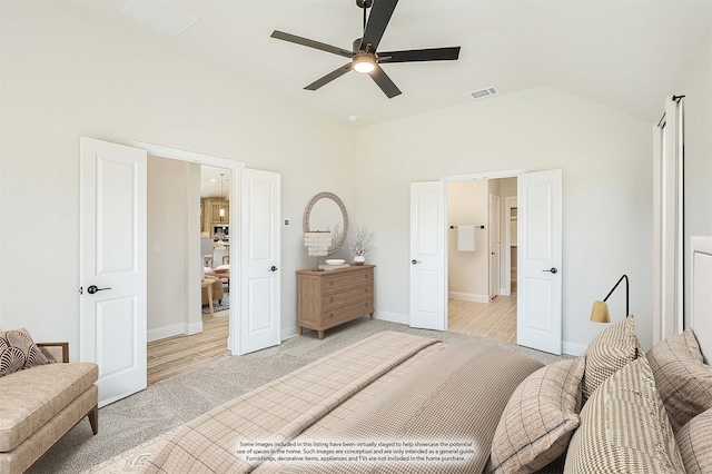 bedroom with light hardwood / wood-style floors, ceiling fan, and vaulted ceiling