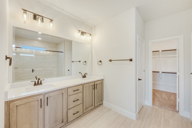 bathroom with walk in shower, vanity, and tile patterned floors