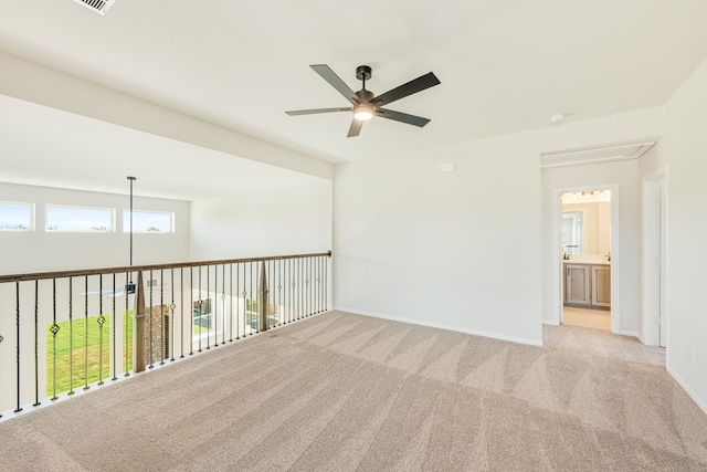 empty room featuring light colored carpet and ceiling fan