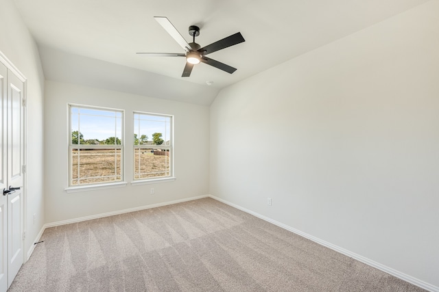 carpeted empty room with lofted ceiling and ceiling fan