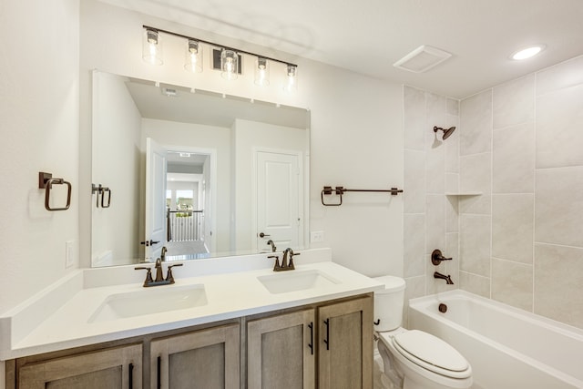 full bathroom featuring vanity, toilet, and tiled shower / bath