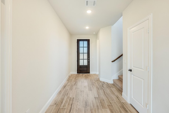 doorway to outside with recessed lighting, stairway, baseboards, visible vents, and light wood-style floors