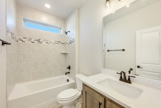 full bathroom with tiled shower / bath, toilet, and vanity