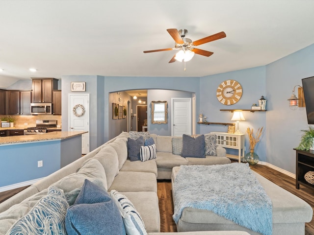 living room featuring dark hardwood / wood-style flooring and ceiling fan