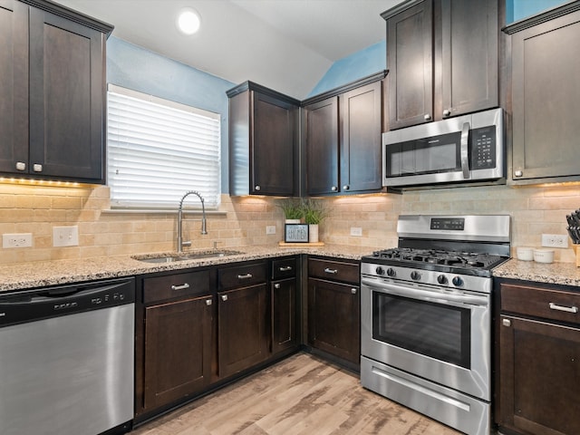 kitchen featuring dark brown cabinetry, sink, and appliances with stainless steel finishes