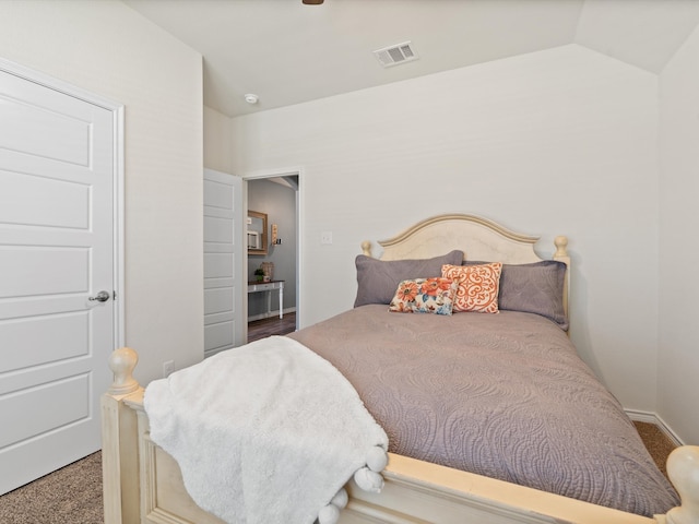 bedroom featuring carpet flooring and vaulted ceiling