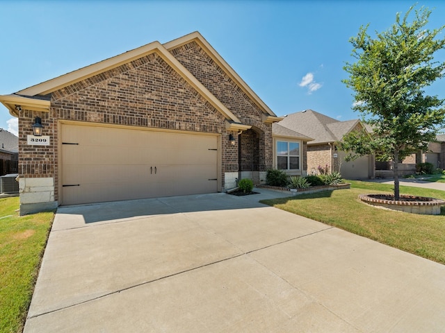 view of front of home featuring a garage and a front lawn