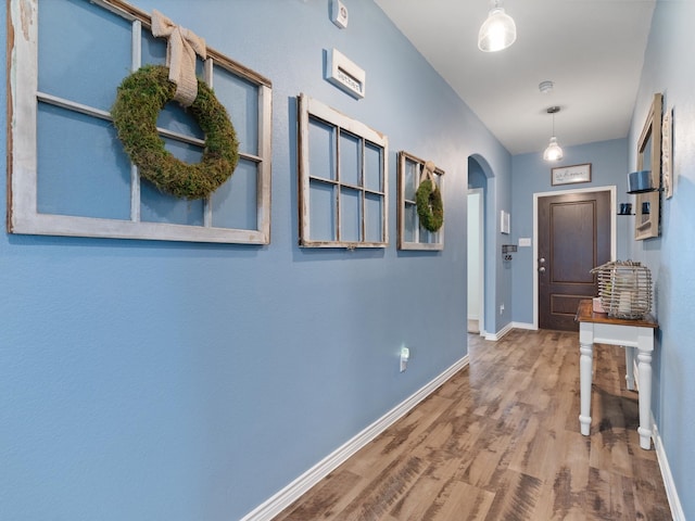 corridor with hardwood / wood-style floors