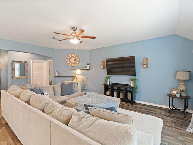 living room featuring ceiling fan, wood-type flooring, and vaulted ceiling