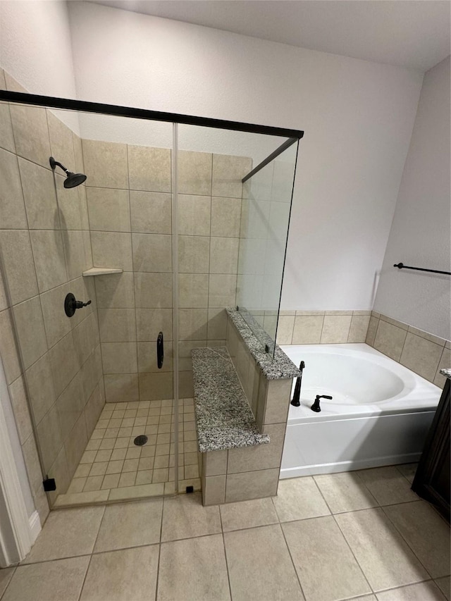 bathroom with tile patterned flooring and independent shower and bath