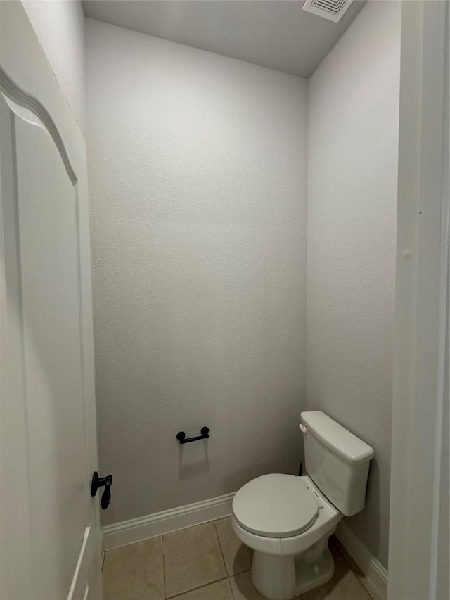 bathroom featuring tile patterned flooring and toilet