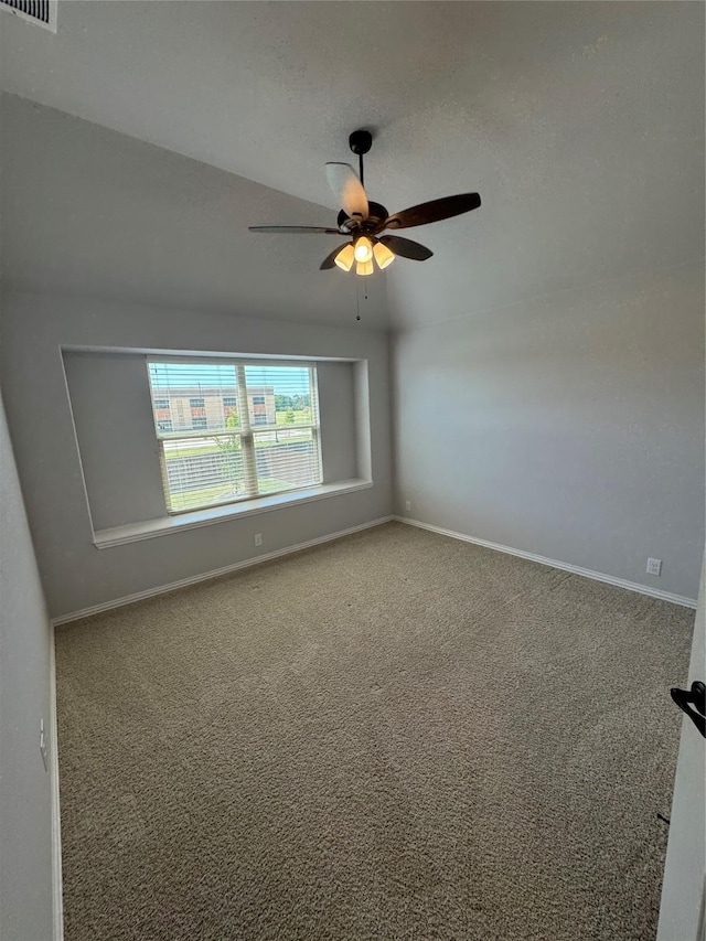 carpeted spare room featuring ceiling fan