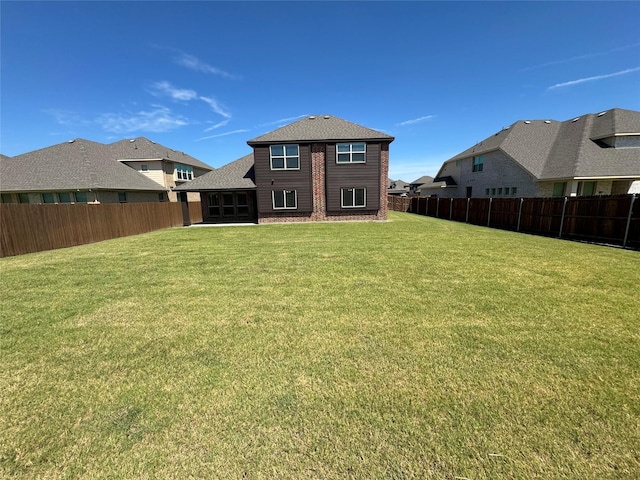 rear view of house featuring a yard