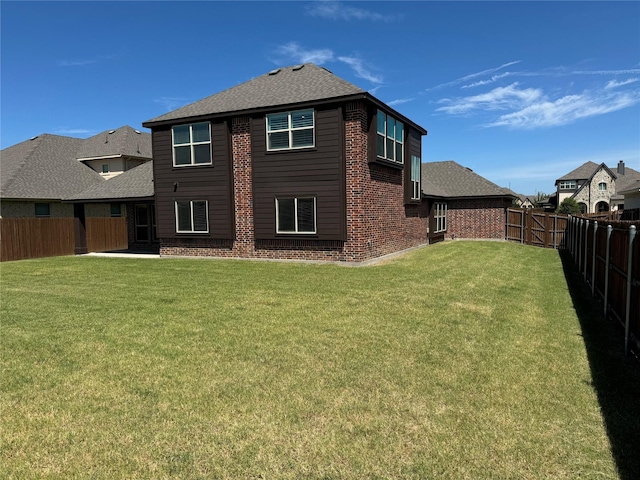 rear view of house with a yard