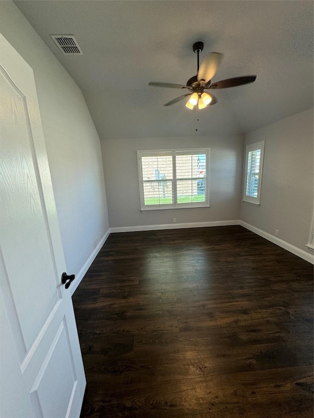 unfurnished room featuring ceiling fan, dark wood-type flooring, and vaulted ceiling