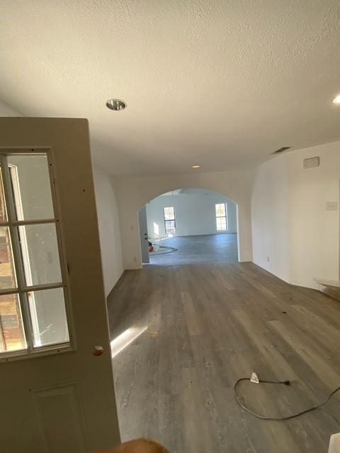 spare room featuring hardwood / wood-style floors and a textured ceiling