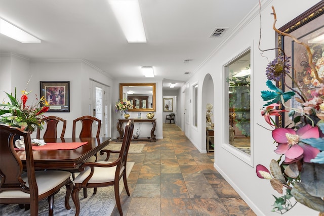 tiled dining room with ornamental molding