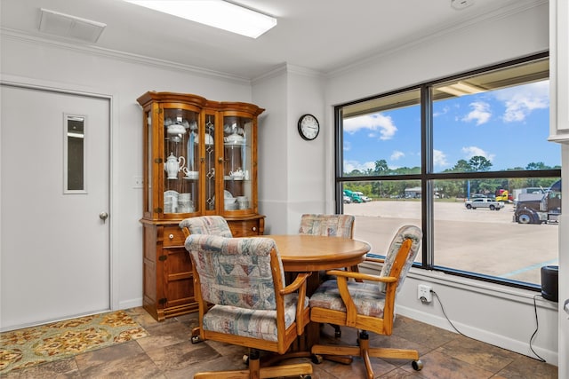 tiled dining space featuring crown molding