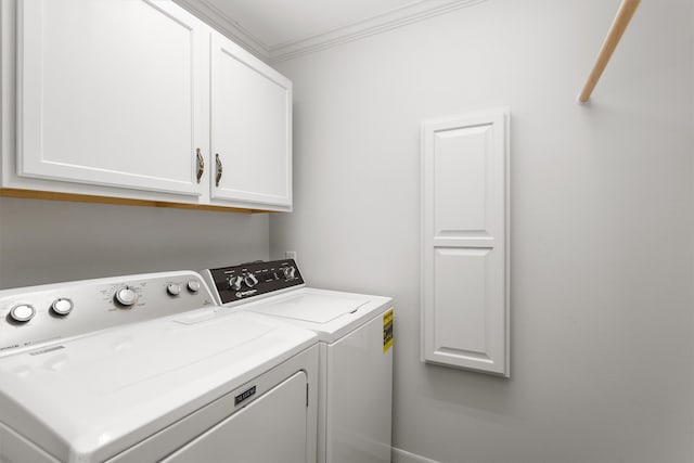 washroom with cabinets, crown molding, and washing machine and clothes dryer