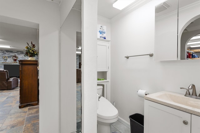 bathroom with vanity, toilet, tile patterned flooring, and crown molding