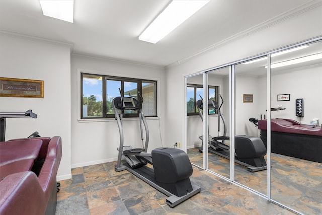 exercise area with crown molding and tile patterned floors