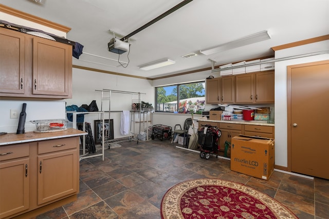 kitchen featuring ornamental molding and dark tile patterned flooring