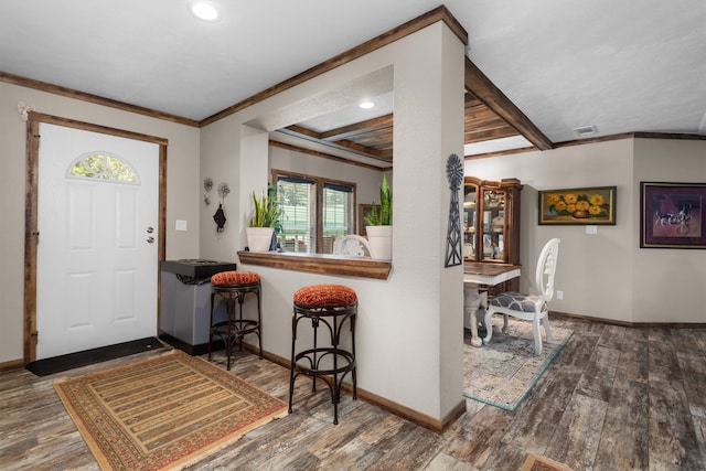 foyer entrance featuring crown molding, hardwood / wood-style flooring, a wealth of natural light, and beam ceiling