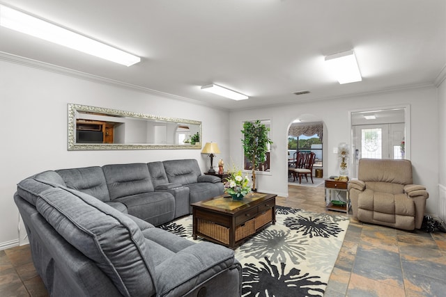 living room with ornamental molding and dark tile patterned floors