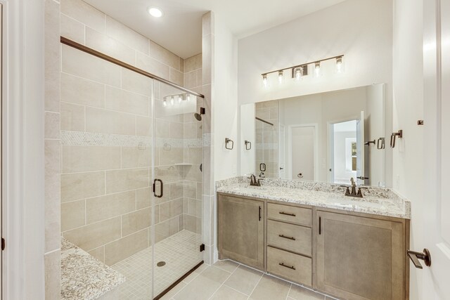 bathroom featuring vanity, walk in shower, and tile patterned floors