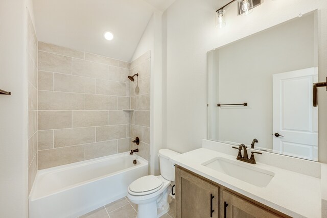 full bathroom with toilet, tile patterned floors, vaulted ceiling, vanity, and tiled shower / bath combo